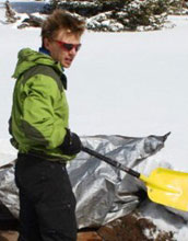 Scientist Adrian Harpold digs out an instrument used to measure snowmelt chemistry.