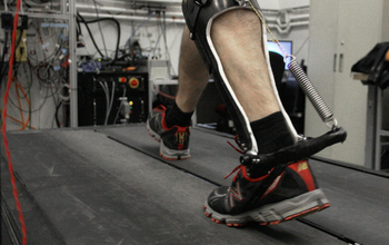 man walking on treadmill with a passive-elastic ankle exoskeleton attached