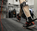 man walking on treadmill with a passive-elastic ankle exoskeleton attached