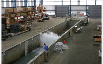 Photo showing a wave impacting a seawall, leading to skyward deflection of momentum.