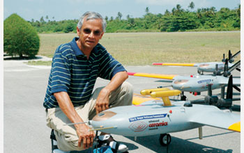 Photo of V. Ramanathan with several autonomous unmanned aerial vehicles.