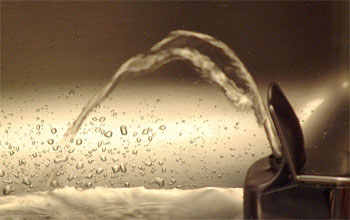 Photo of a water coming out of a water fountain.