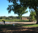 Photo of Scott Simpson taking samples from the San Pedro River in Arizona.