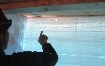 scientist pointing at an ice sheet