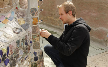 Graduate Student Jackson English installing crack displacement sensors on the Watts Towers