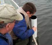 Citizen volunteers have been trained to measure water clarity with a Secchi disk and view tube.