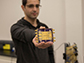 Hossein Jalili displays the millimeter-wave/terahertz phased array chip