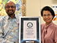 Amar Balla and Ruyan Guo hold up the certificate