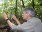 Brent Opell collects a portion of a spider web