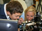 students look at a butterfly