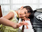 a little girl at a piano