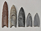 a collection of Clovis point replicas and casts in the archaeology lab