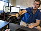 David Caldwell tests the hardware used for stimulating and recording a patient's brain surface