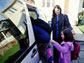 a mother and kids getting in a car