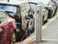 electric vehicles plug in to charging stations