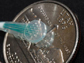 16 microelectrodes next to a U.S. quarter