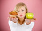 a lady holding a muffin and an apple