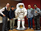 researchers pose with a model of an astronaut