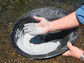 hands holding a pot with natural clay