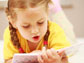 a little girl reading a book