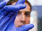 Graduate student Nicholas Davy holds a sample of the special window glass