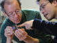 engineers examine wireless sensing device