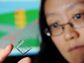 Hang Lu holding a microfluidic chip