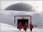 Photo of men walking into 1975 South Pole station entrance