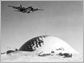 Photo of LC-130 flying over dome of South Pole station