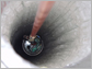 Photo of DOM lowered into IceCube hole drilled in the ice