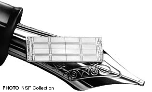 Comparison of a foundation pen for writing and a computer chip. Photo NSF Collection.