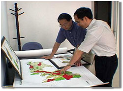 2 researchers looking at a map