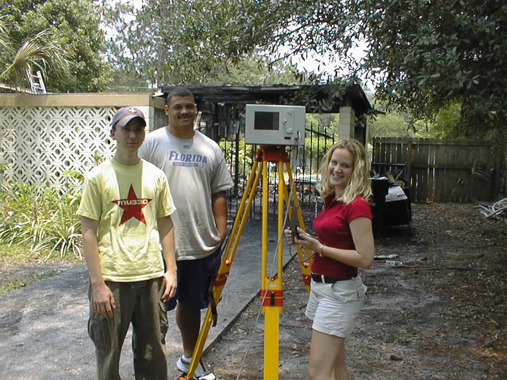In their summer program, Jonathan Sanek, Ian Scott, and Laura DeAngelo will be using an OPTECH, Inc. 3-D laser imager to assess damage to structures.