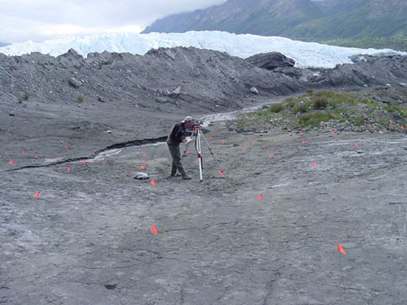 Dallas Trople, a high school science teacher in Sedro-Woolley, Washington, measures elevations at a research site in Alaska, where he is part of a team studying changes in topography brought on by a melting glacier.