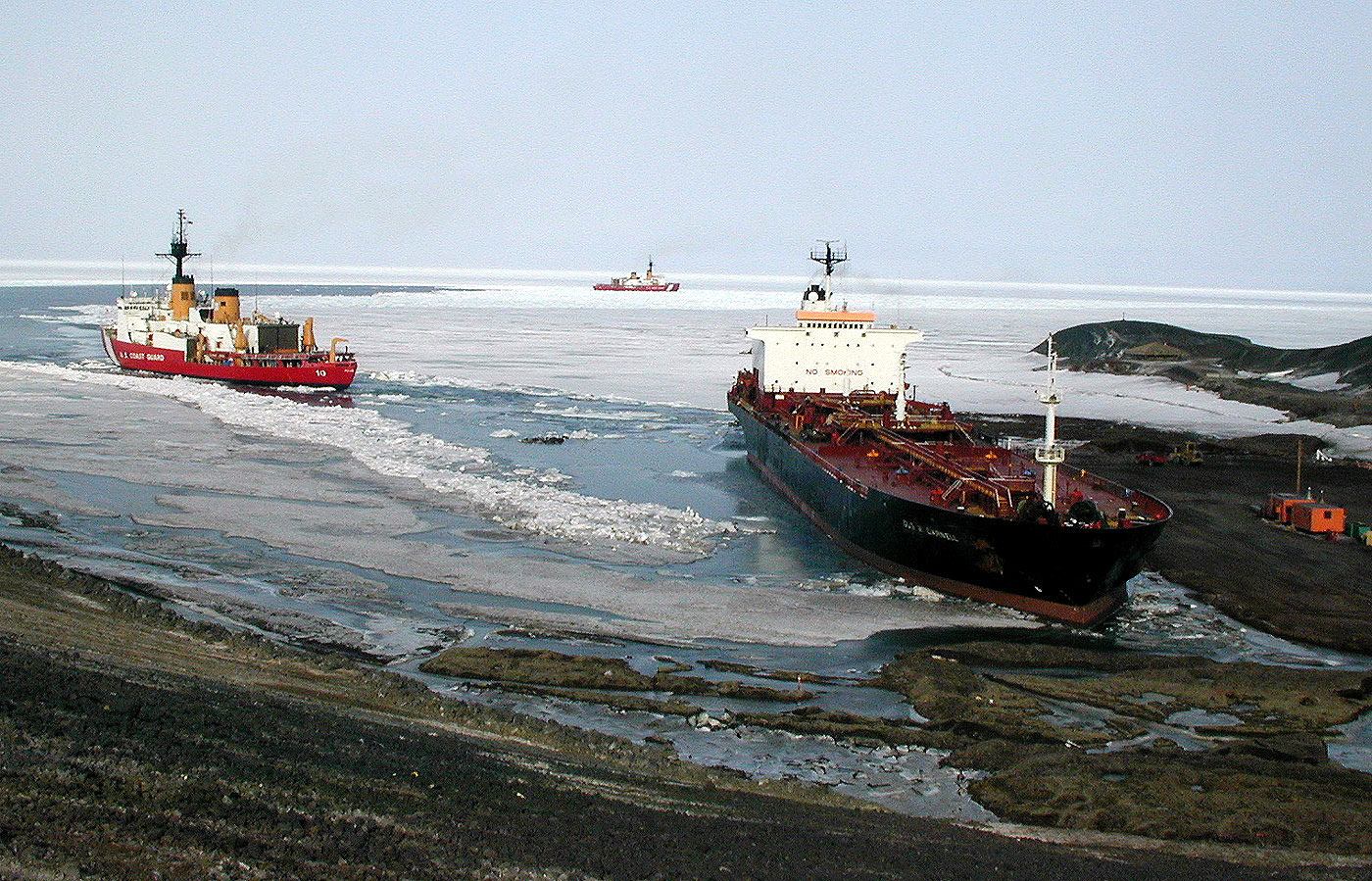 the icebreakers guide the tanker Gus C. Darnell
