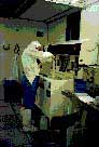 Graduate student rinsing wafers in cleanroom laboratory