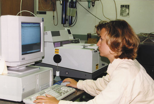 Anneke Kaminski, a graduate student at NDSU, operating a Fourier Transform stepscann Infrared Spectrometer.